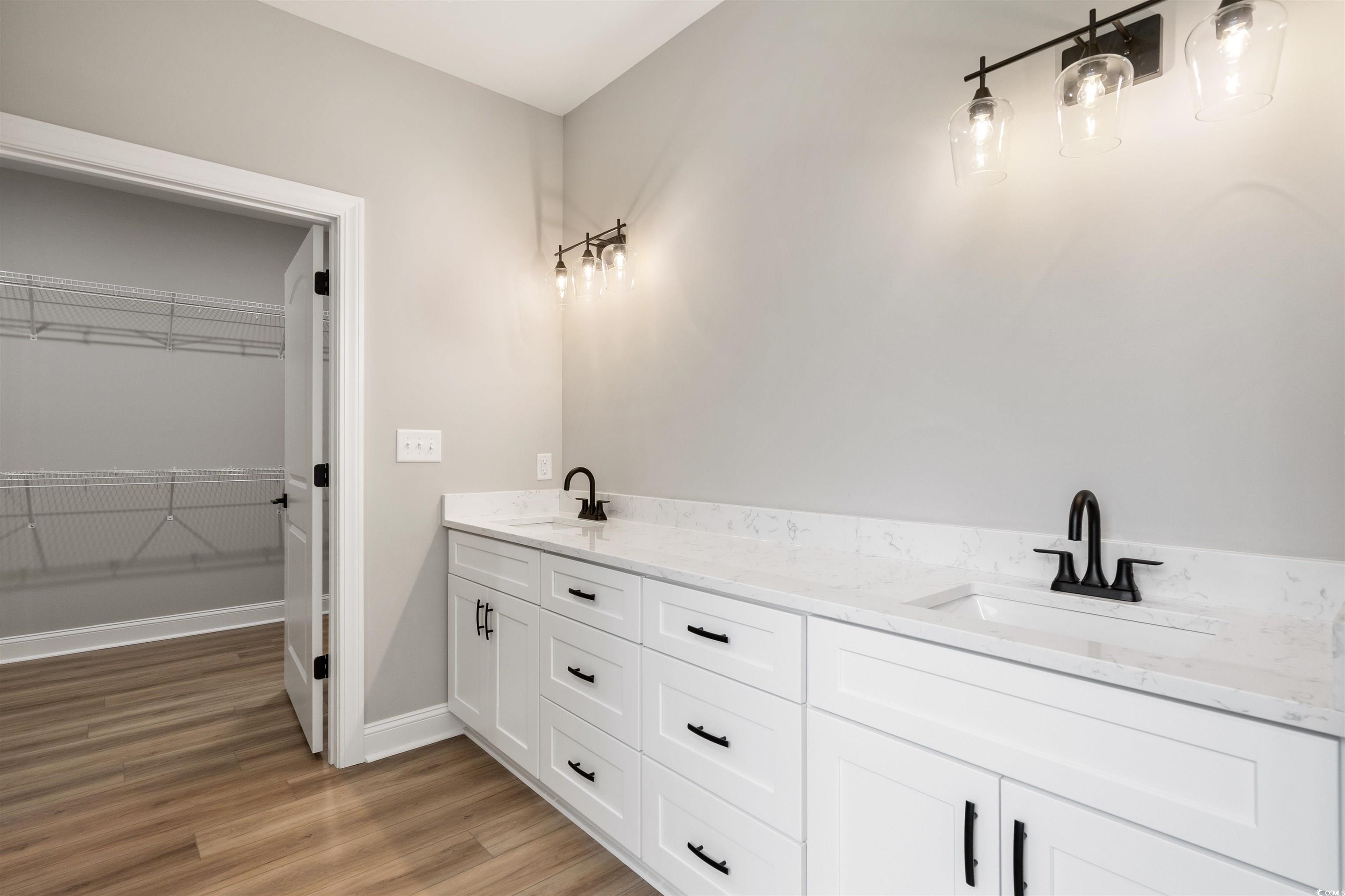 6909 Pauley Swamp Road Conway, SC 29527 - Photo 27 of 40 Bathroom with vanity and hardwood / wood-style flo