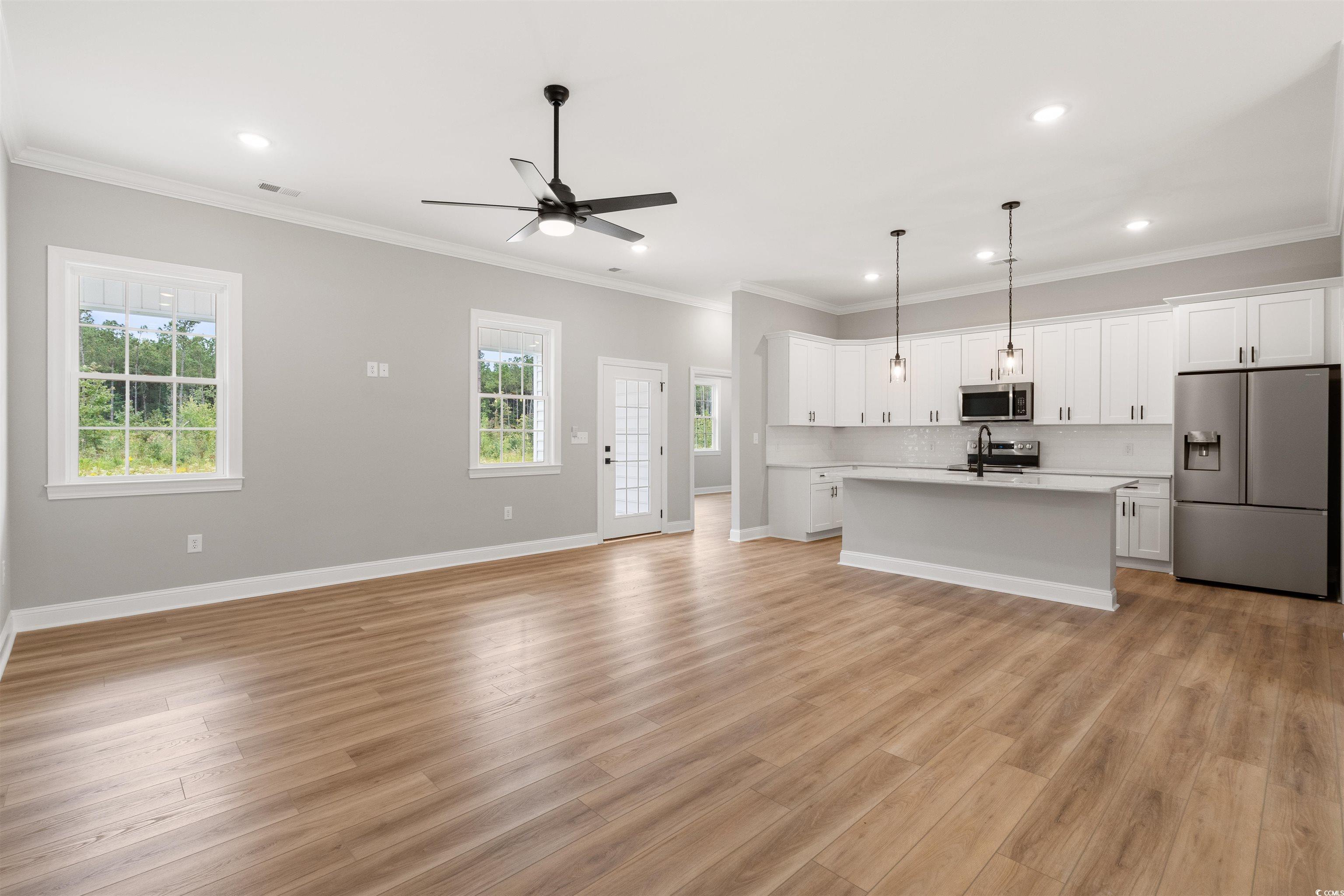 6909 Pauley Swamp Road Conway, SC 29527 - Photo 8 of 40 Unfurnished living room with light hardwood / wood
