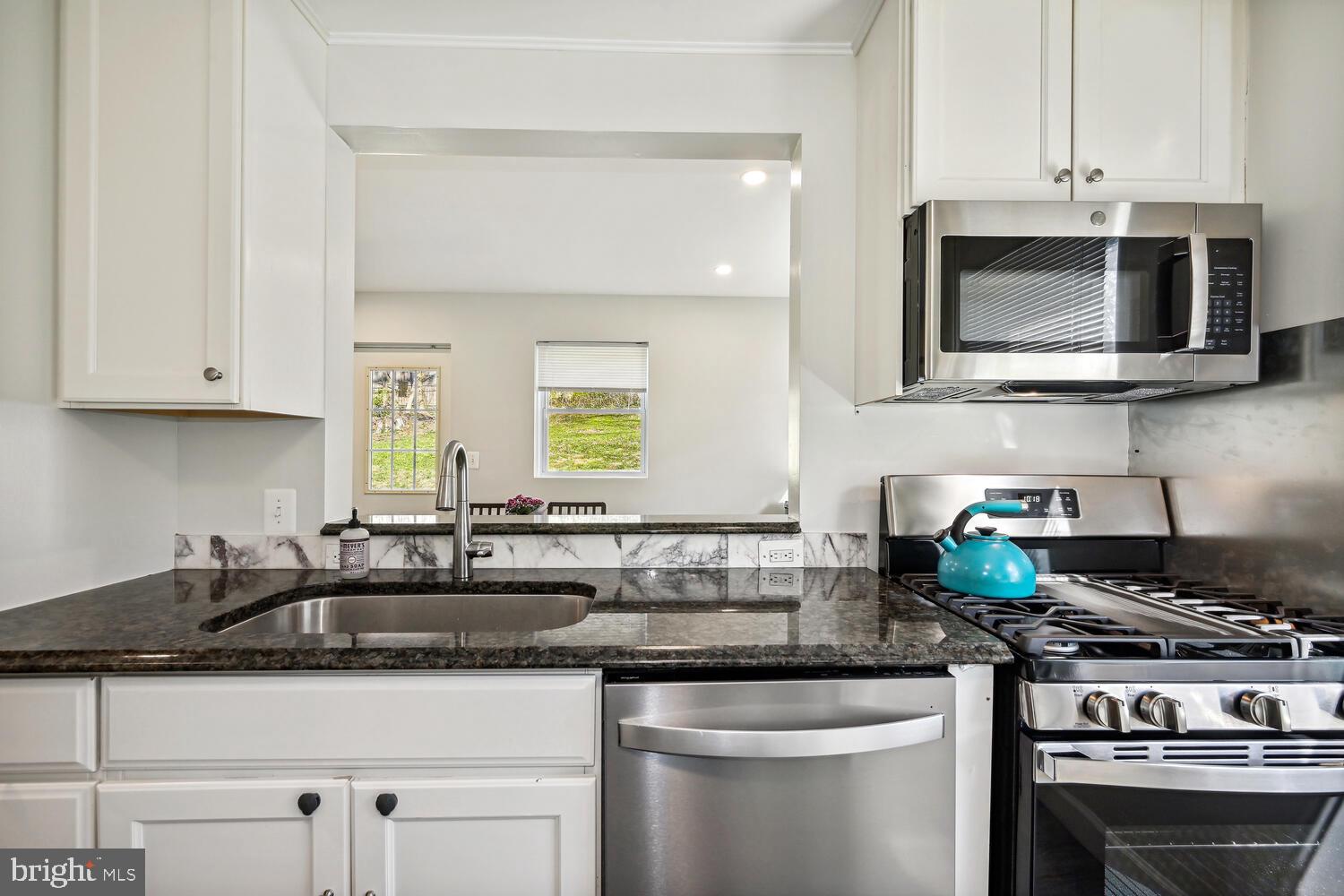 Sleek granite counters & new stainless appliances