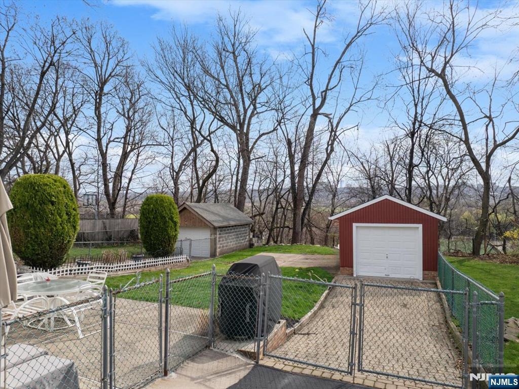 119 Overpeck Avenue Ridgefield Park, NJ 07660 - Photo 32 of 44 a front view of a house with a garden and trees