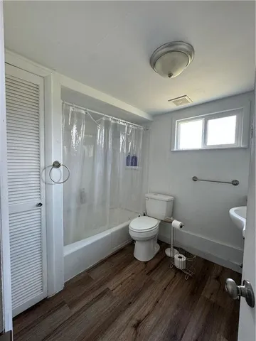 a bathroom with a toilet a sink and shower