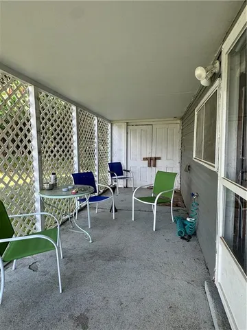 a living room with furniture lamp and a window