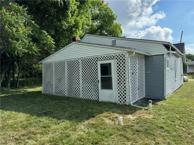 a view of a small house with a yard