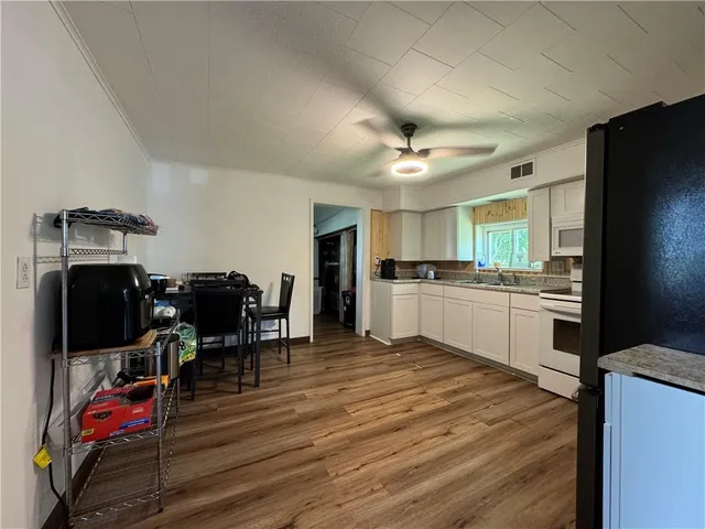 a kitchen with furniture and a wooden floor