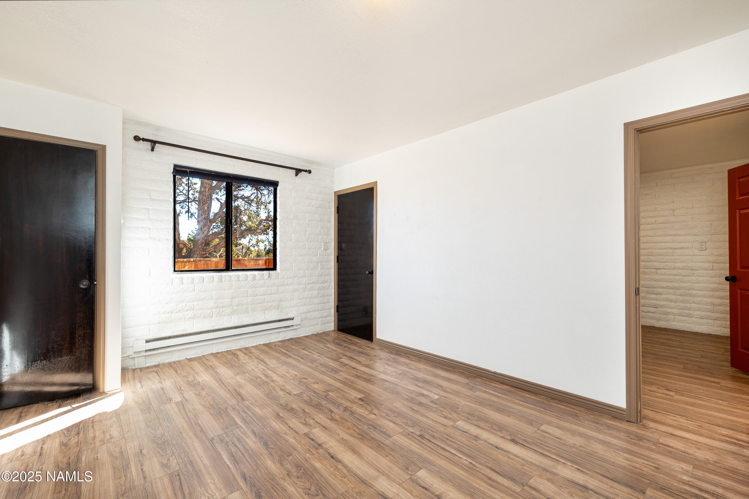 5966 East Camden Road Flagstaff, AZ 86004 - Photo 12 of 70 an empty room with wooden floor and windows