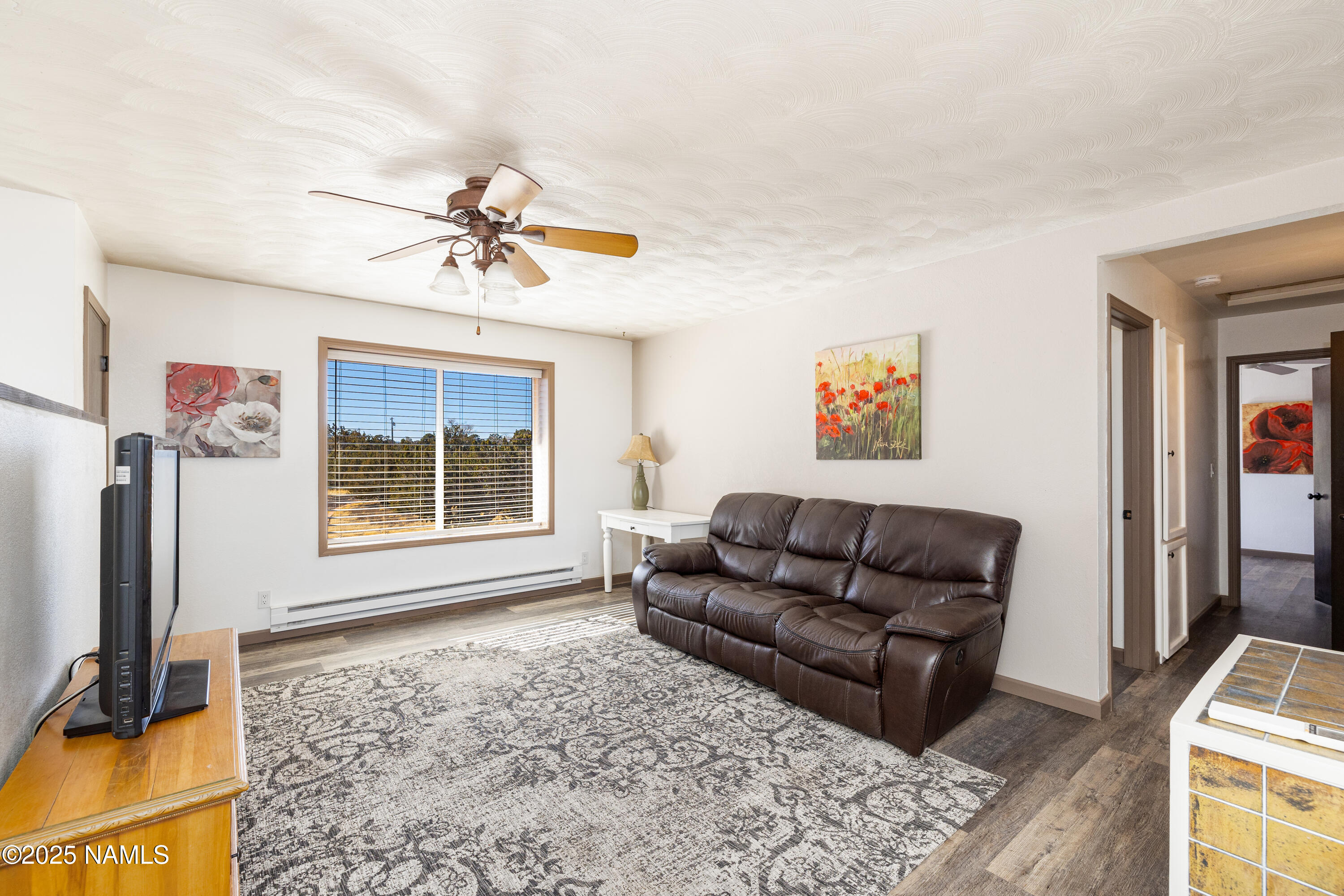 5966 East Camden Road Flagstaff, AZ 86004 - Photo 15 of 70 a living room with furniture and a flat screen tv