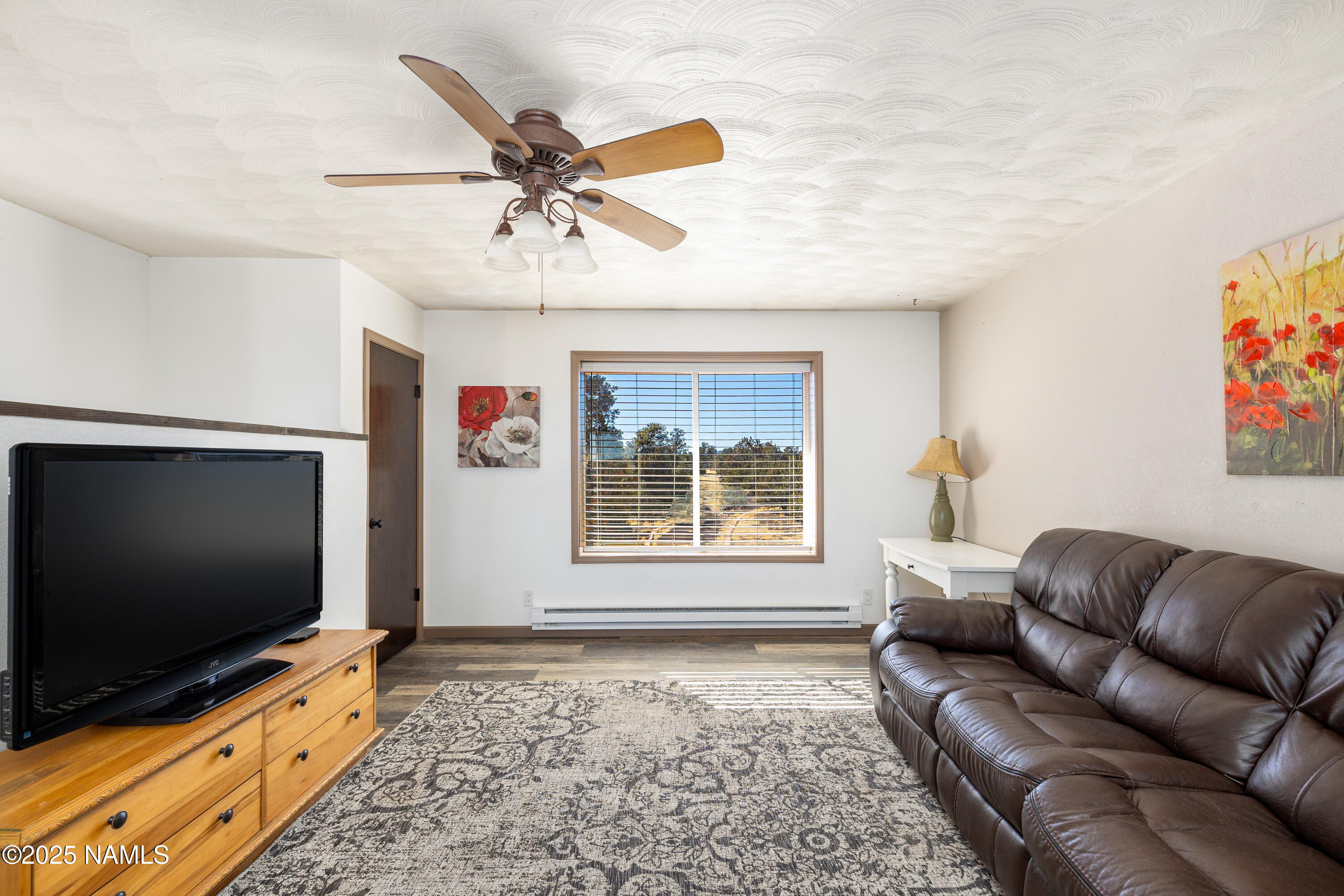 5966 East Camden Road Flagstaff, AZ 86004 - Photo 16 of 70 a living room with furniture and a flat screen tv