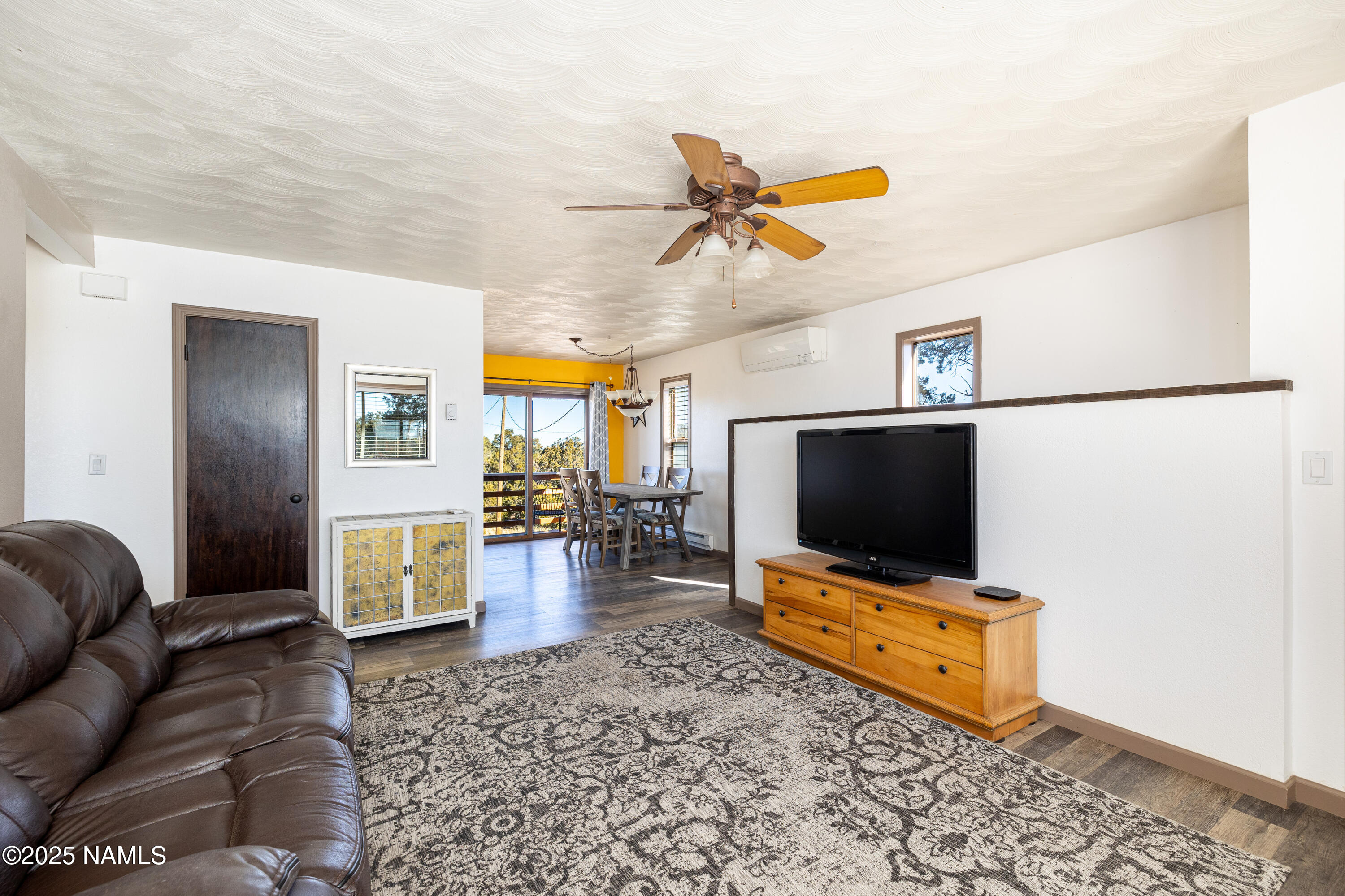 5966 East Camden Road Flagstaff, AZ 86004 - Photo 17 of 70 a living room with furniture and a flat screen tv