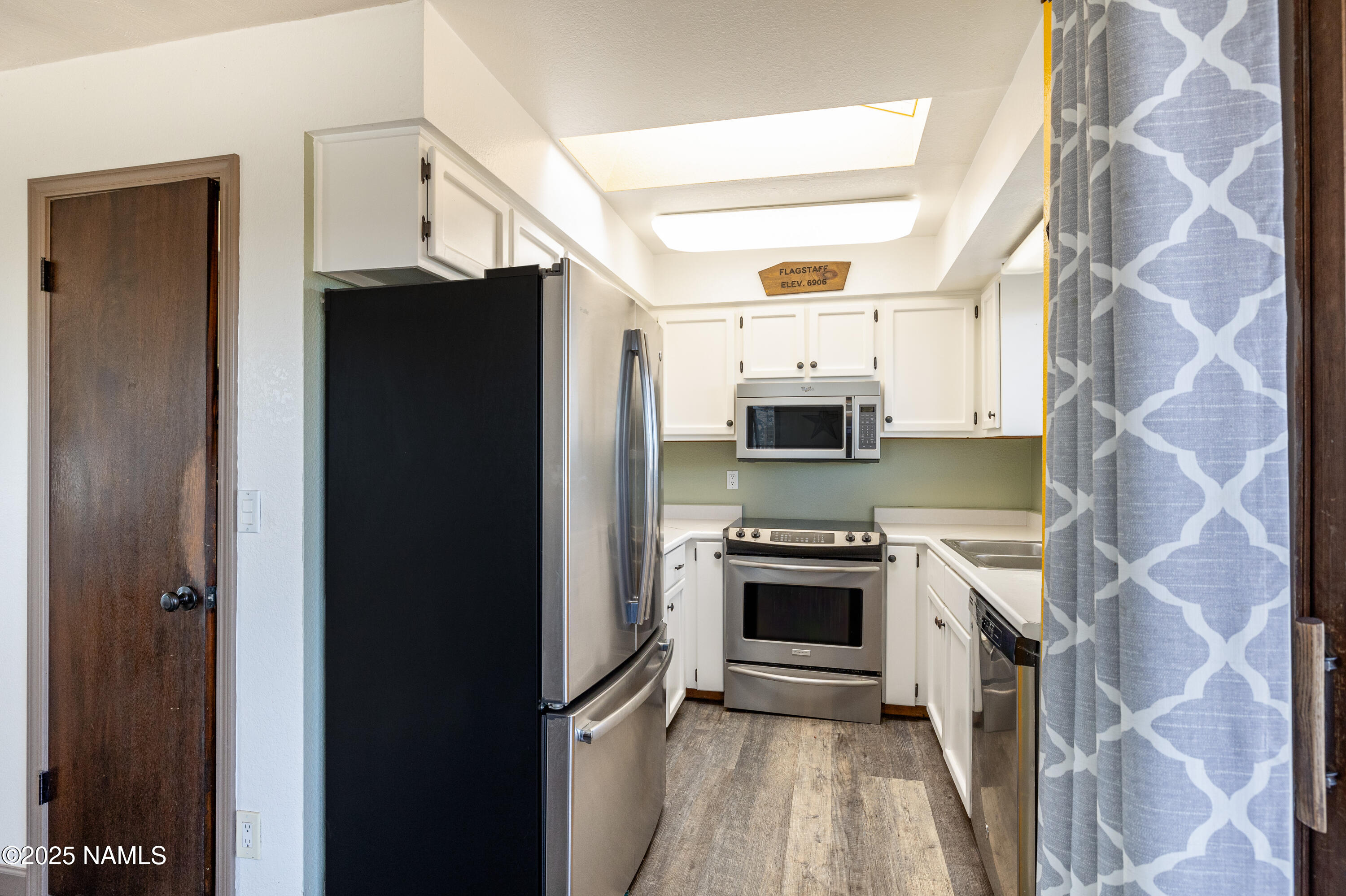 5966 East Camden Road Flagstaff, AZ 86004 - Photo 19 of 70 a kitchen with stainless steel appliances a refrigerator a stove and a sink