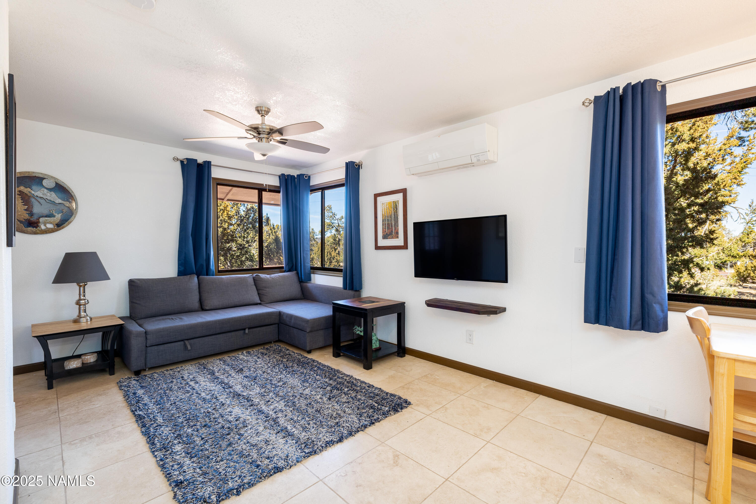 5966 East Camden Road Flagstaff, AZ 86004 - Photo 38 of 70 a living room with furniture and a flat screen tv