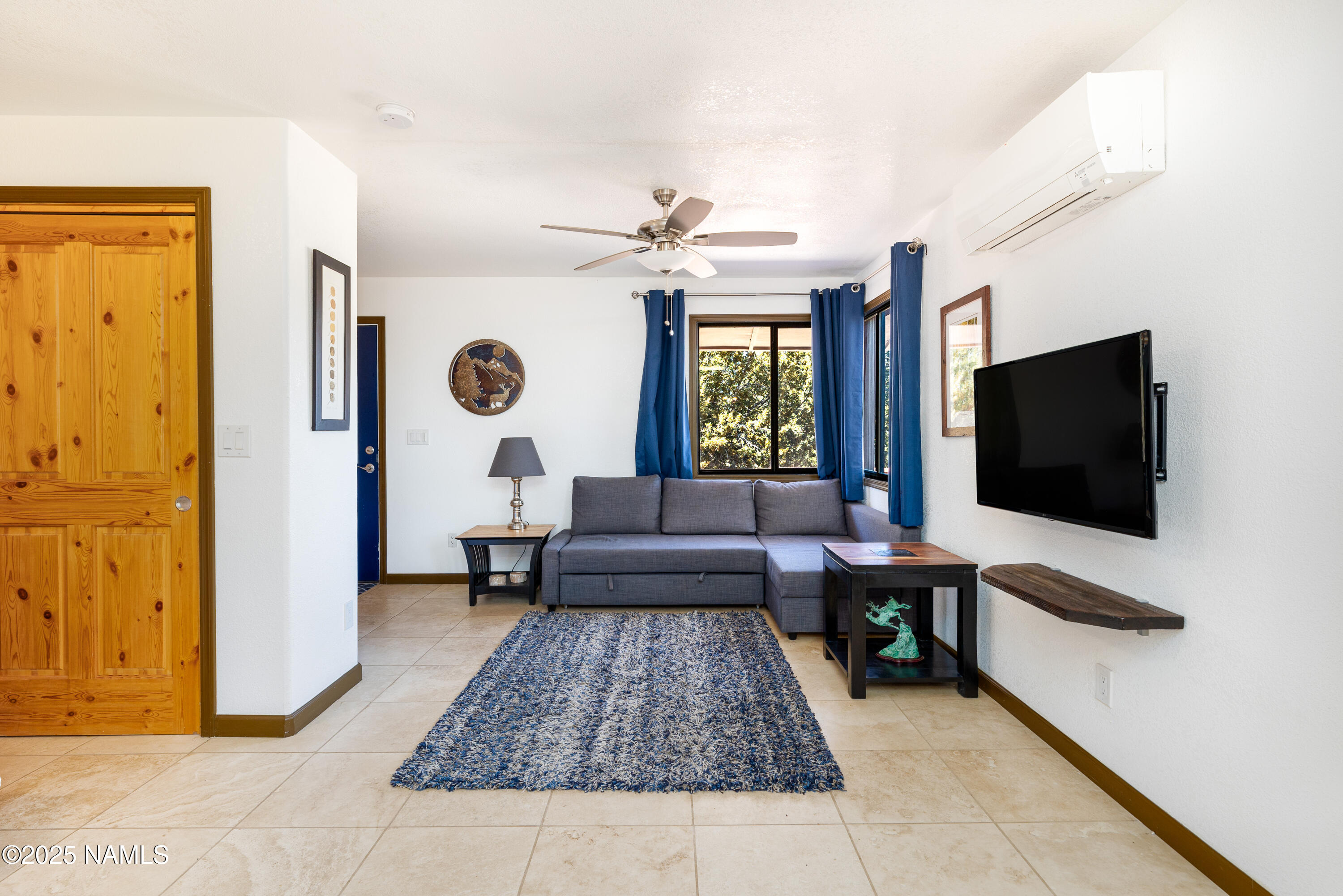 5966 East Camden Road Flagstaff, AZ 86004 - Photo 39 of 70 a living room with furniture and a flat screen tv