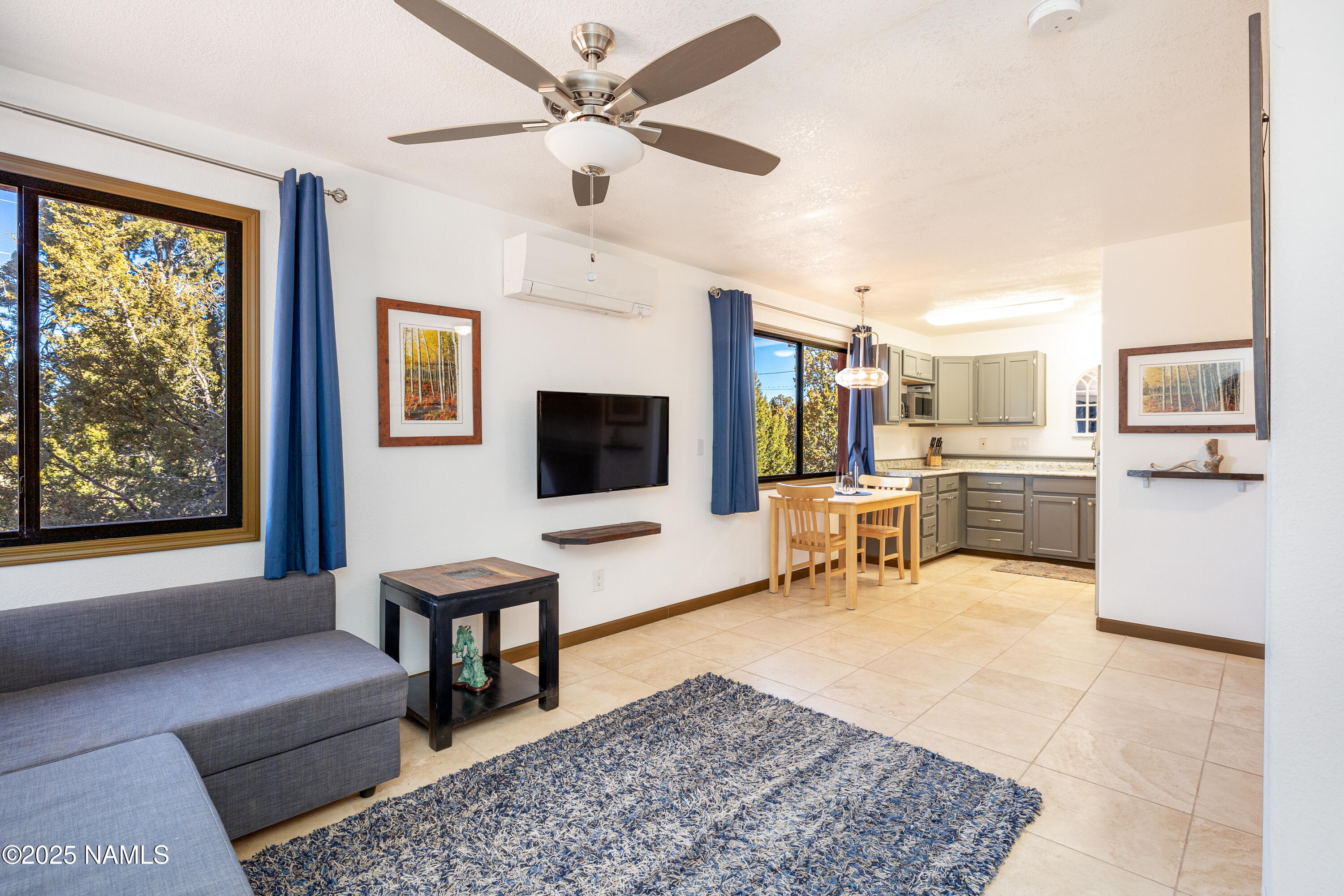 5966 East Camden Road Flagstaff, AZ 86004 - Photo 41 of 70 a living room with furniture and a flat screen tv