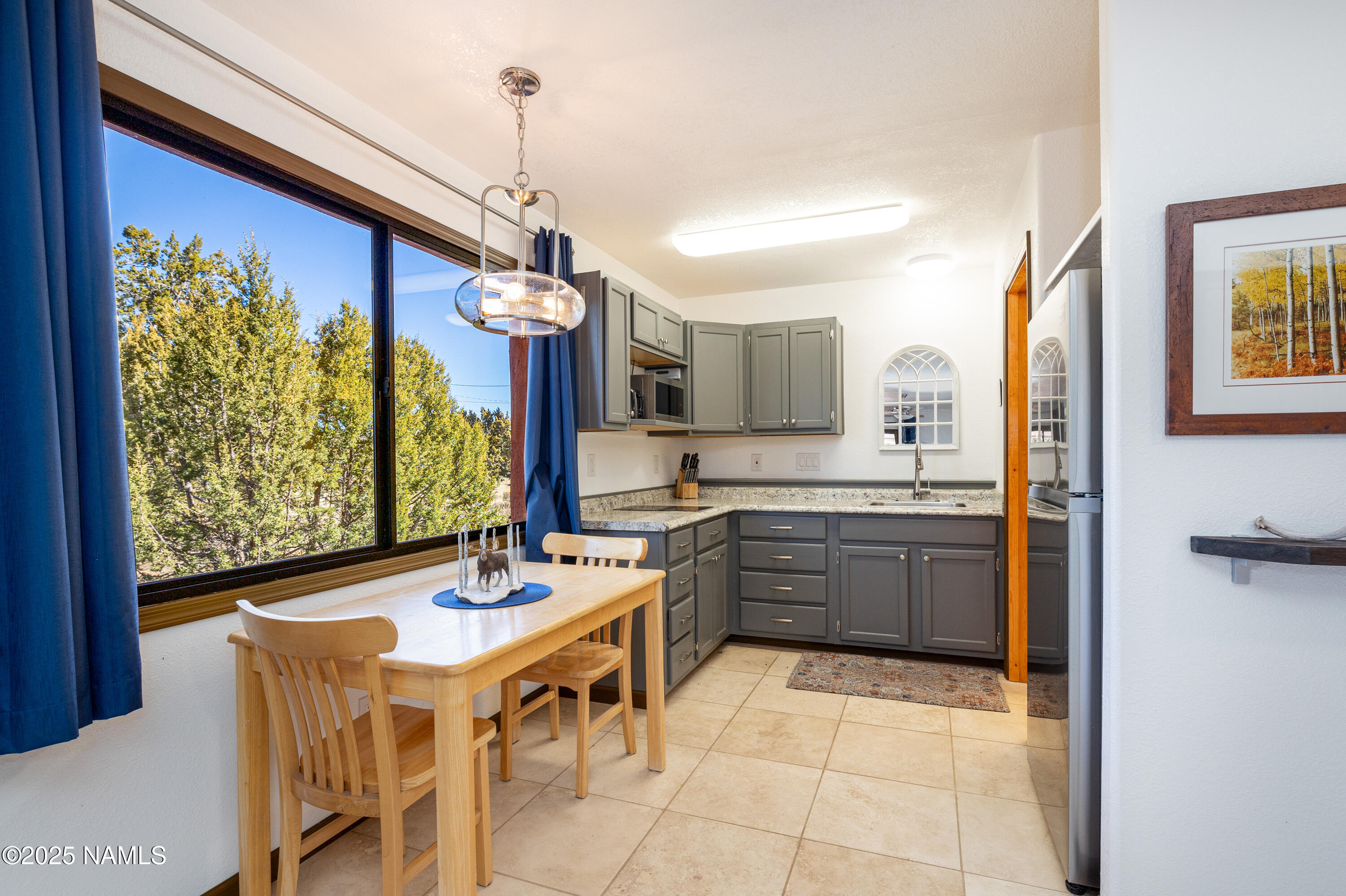 5966 East Camden Road Flagstaff, AZ 86004 - Photo 43 of 70 a kitchen with a table and chairs in it