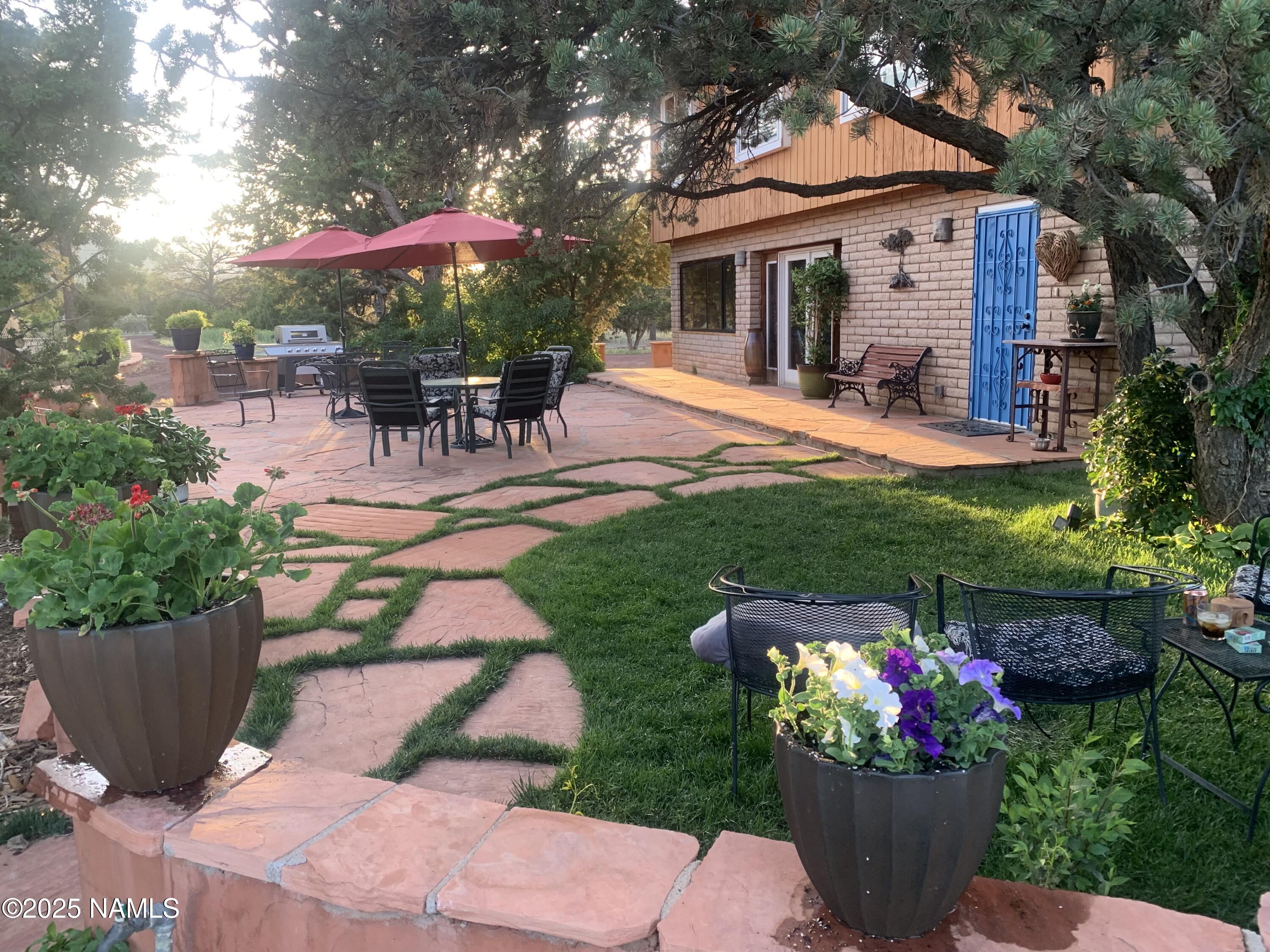 5966 East Camden Road Flagstaff, AZ 86004 - Photo 65 of 70 a view of a house with backyard sitting area and garden