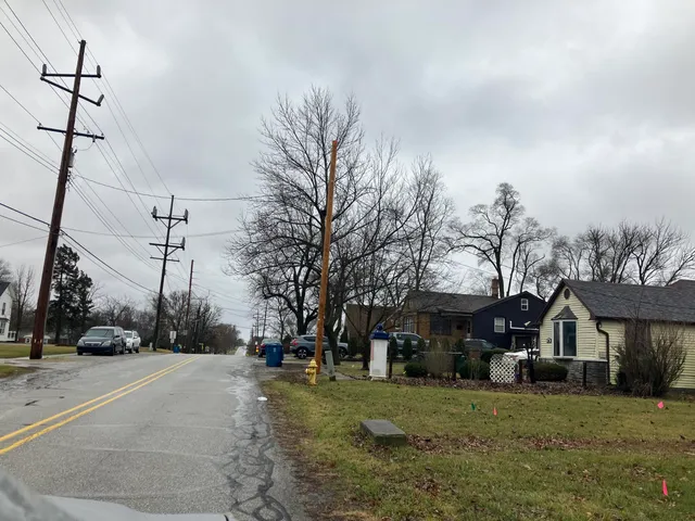 a view of house with car parked beside of it