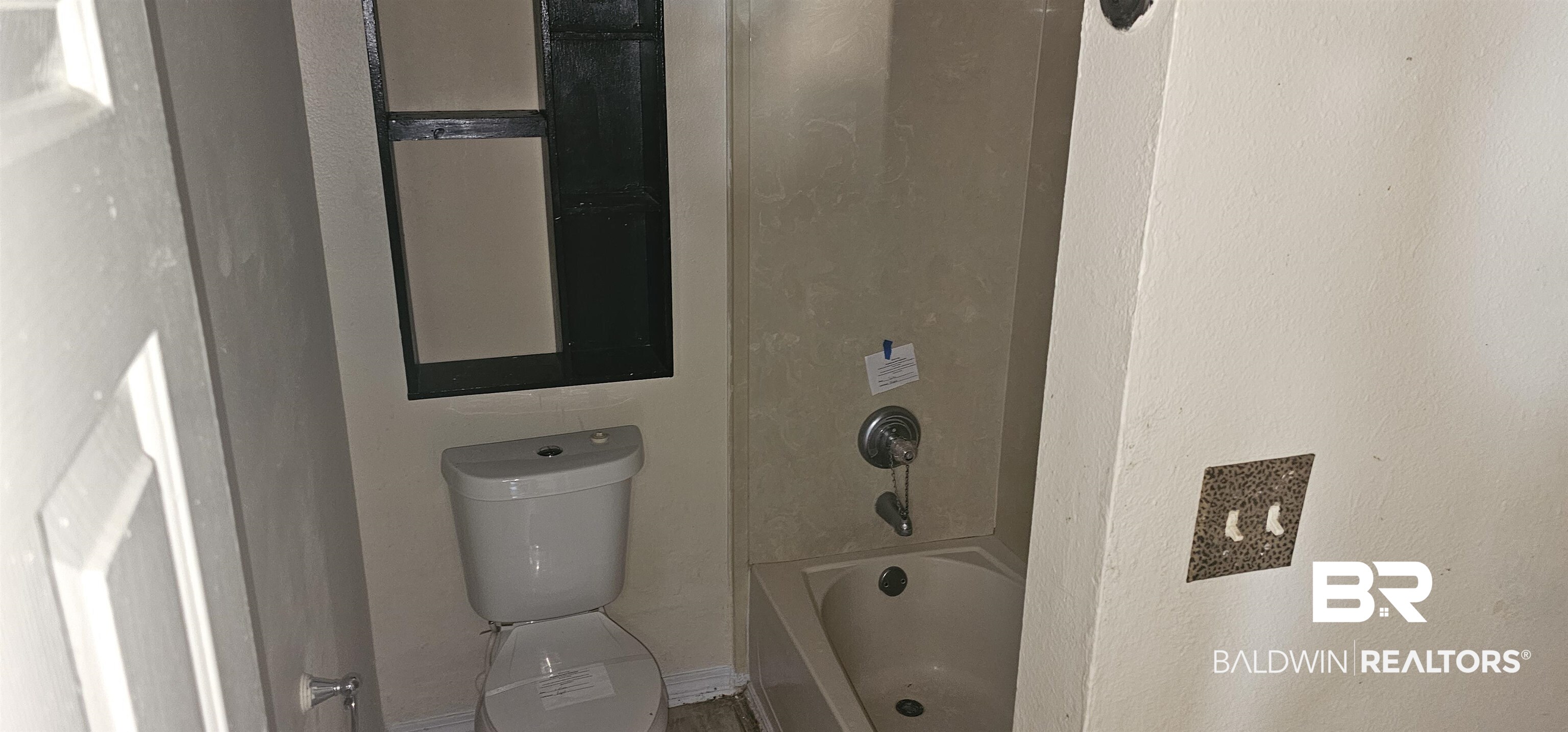 151 Bullard Street Atmore, AL 36502 - Photo 9 of 38 Bathroom view of a textured wall and shower / tub combination