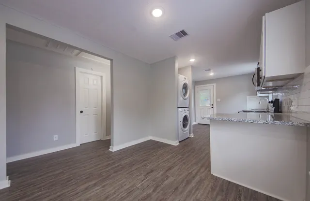 a view of kitchen with wooden floor and electronic appliances
