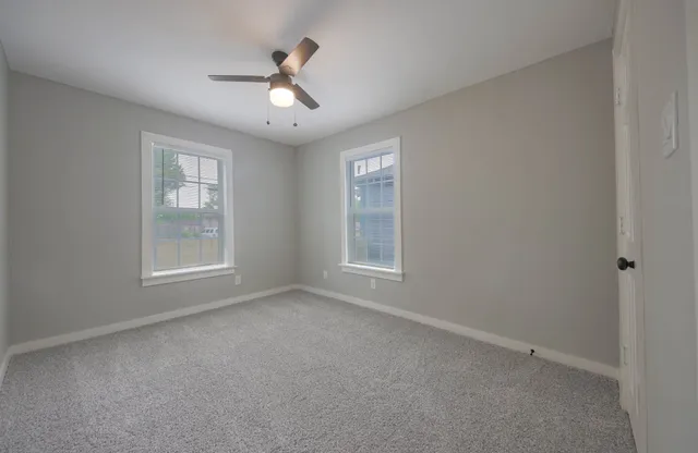 a view of room with window and ceiling fan