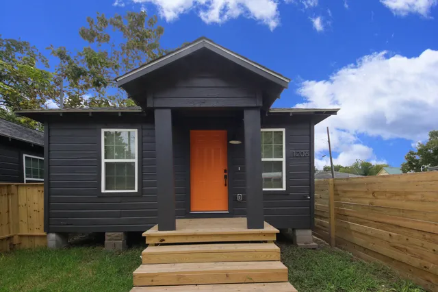 a front view of a house with a garden