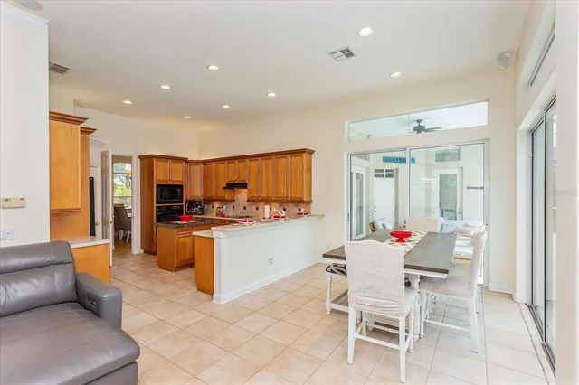 a kitchen with stainless steel appliances kitchen island granite countertop a stove and a refrigerator