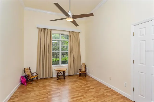 a view of a room with wooden floor and windows