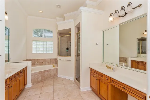 a spacious bathroom with a tub sink shower and mirror