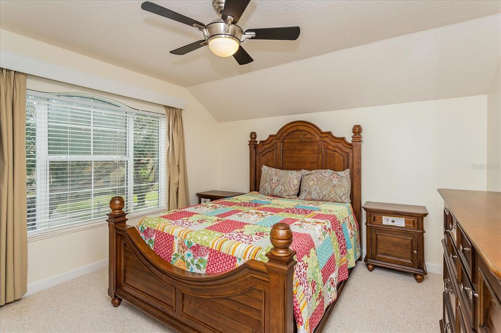 10606 Boca Pointe Drive Orlando, FL 32836 - Photo 31 of 39 a bedroom with a bed and a chandelier