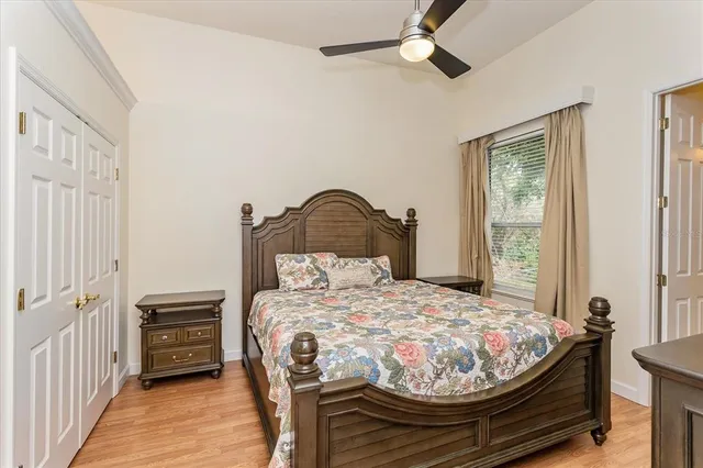 a bedroom with a bed and wooden floor