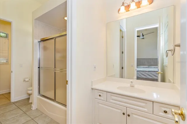 a bathroom with a shower sink and mirror