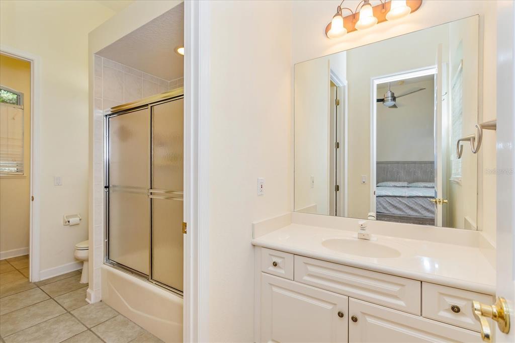 10606 Boca Pointe Drive Orlando, FL 32836 - Photo 35 of 39 a bathroom with a shower sink and mirror