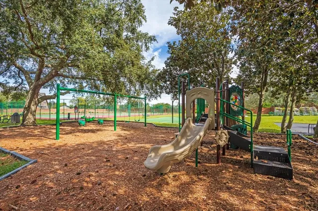 a view of a park with swings and slides