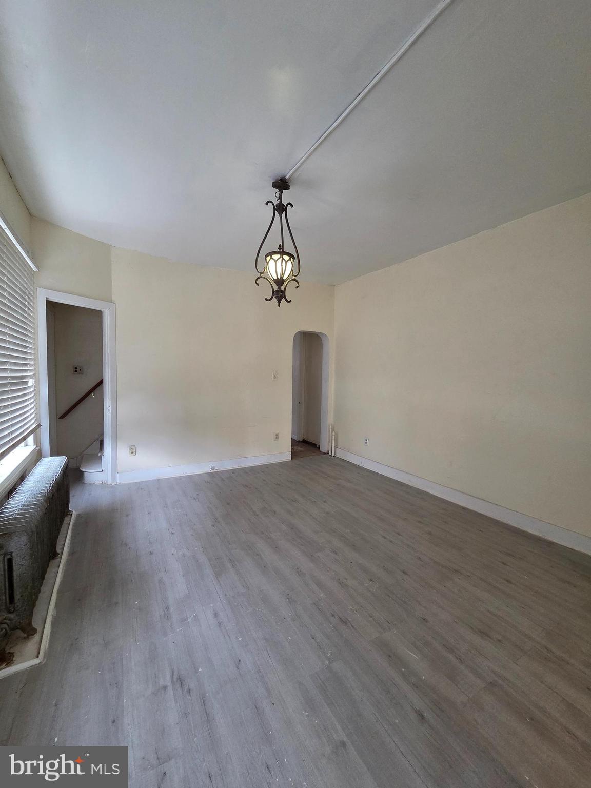 1135 Cotton Street Reading, PA 19602 - Photo 5 of 17 a view of a livingroom with wooden floor and a ceiling fan