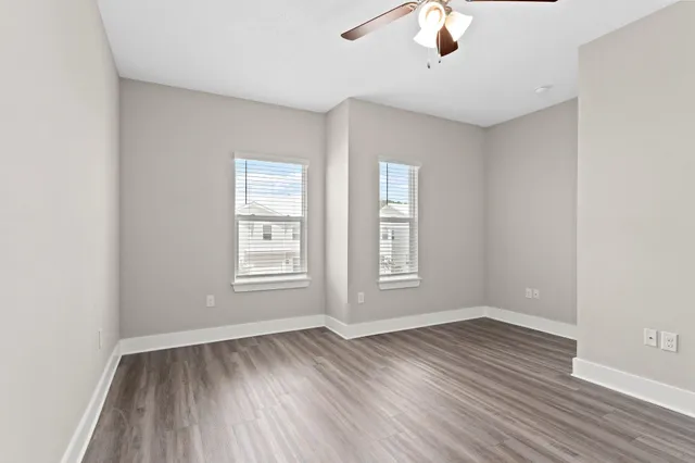 wooden floor in an empty room with a window