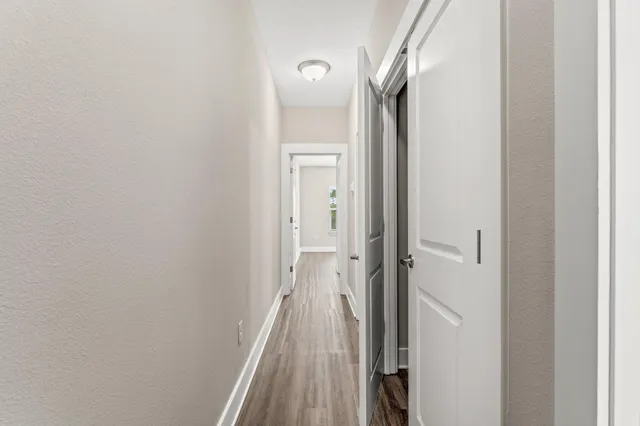 a view of a bathroom from a corridor