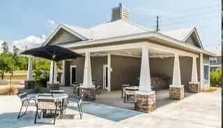 a view of a patio with table and chairs and potted plants
