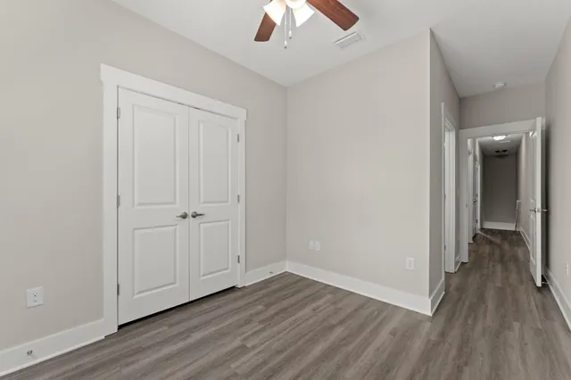 a view of a hallway with wooden floor