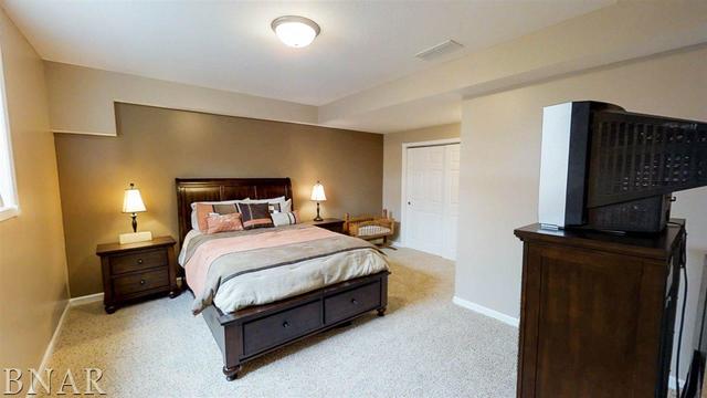 8166 Idlewood Road Clinton, IL 61727 - Photo 22 of 24 a bedroom with a bed and a television