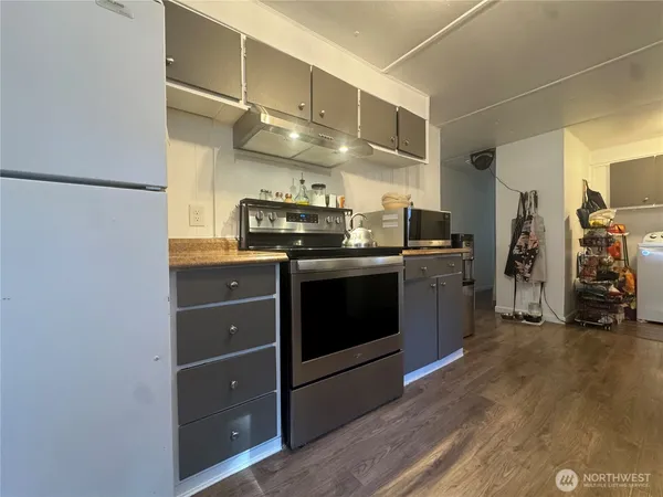 a kitchen with stainless steel appliances granite countertop a stove and a refrigerator