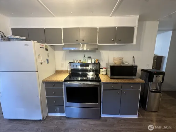 a kitchen with stainless steel appliances a stove a refrigerator and cabinets
