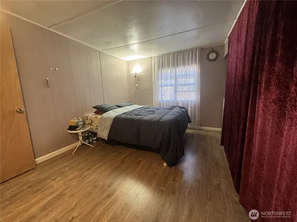 a bedroom with a bed and a window