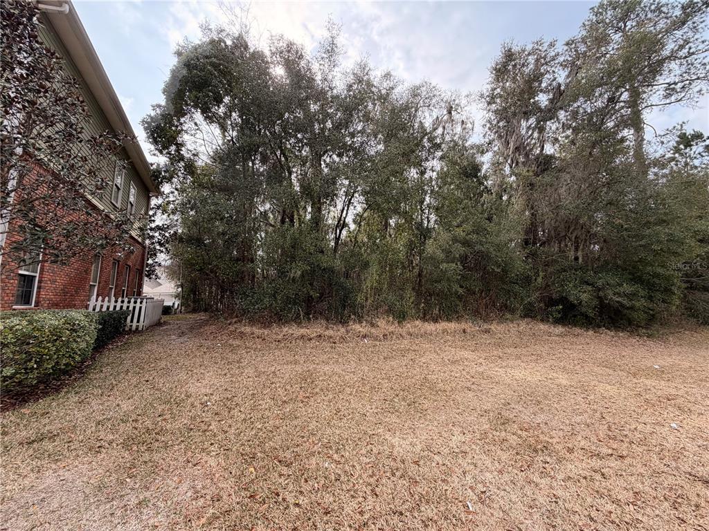 2611 Southwest 87th Drive Gainesville, FL 32608 - Photo 2 of 6 a view of dirt yard with a trees