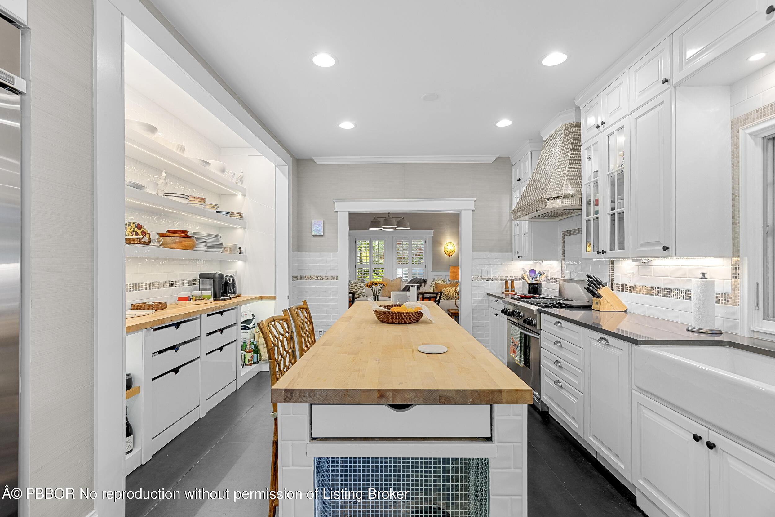 321 Croton Way West Palm Beach, FL 33401 - Photo 17 of 40 a kitchen with granite countertop kitchen island wooden cabinets and stainless steel appliances