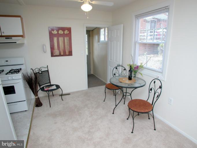 7920 Ridgely Oak Road Parkville, MD 21234 - Photo 1 of 13 a living room with furniture and a potted plant