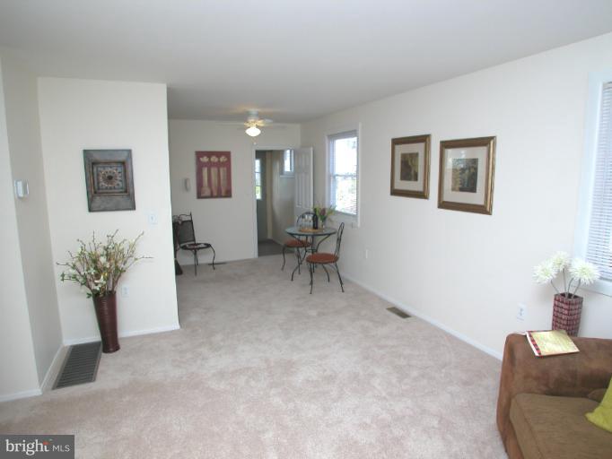 7920 Ridgely Oak Road Parkville, MD 21234 - Photo 3 of 13 a living room with furniture and a potted plant