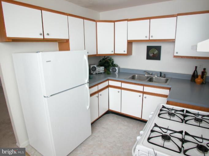 7920 Ridgely Oak Road Parkville, MD 21234 - Photo 9 of 13 a white refrigerator freezer sitting inside of a kitchen