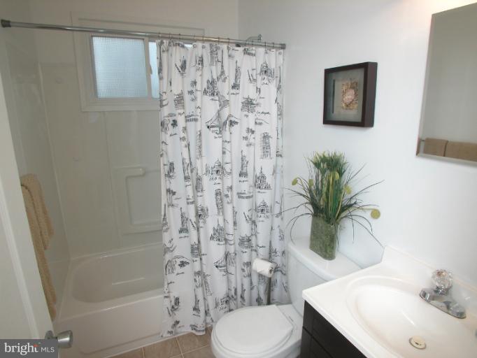 7920 Ridgely Oak Road Parkville, MD 21234 - Photo 10 of 13 a bathroom with a sink toilet and shower