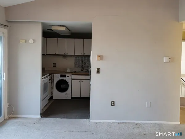 a view of a storage & utility room with a washer dryer