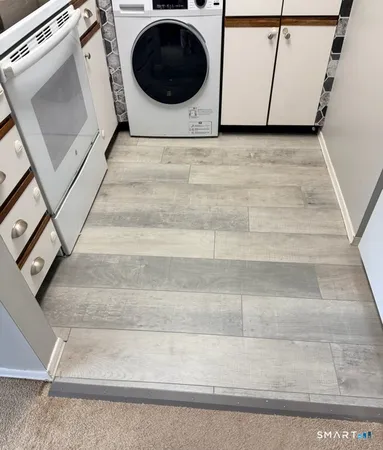 a view of a hallway with washer and dryer