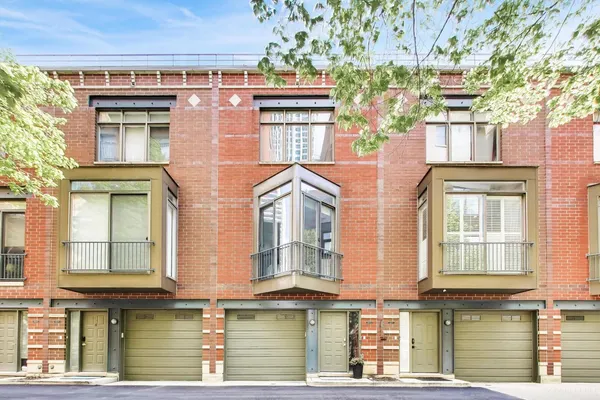 a front view of a residential apartment building with a yard