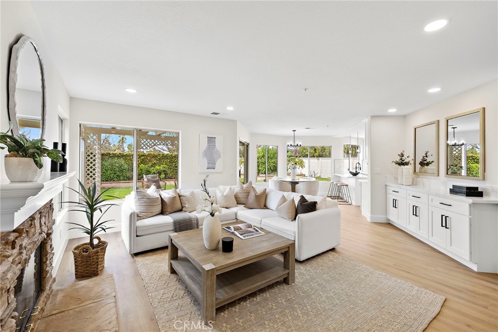 a living room with furniture large window and a table